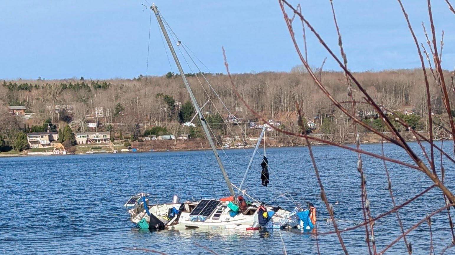 Police monitoring man living on grounded, listing sailboat near Discovery Harbour